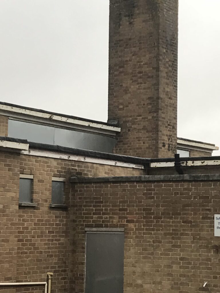Commercial vacant property secured with fencing and MW Global Security signage