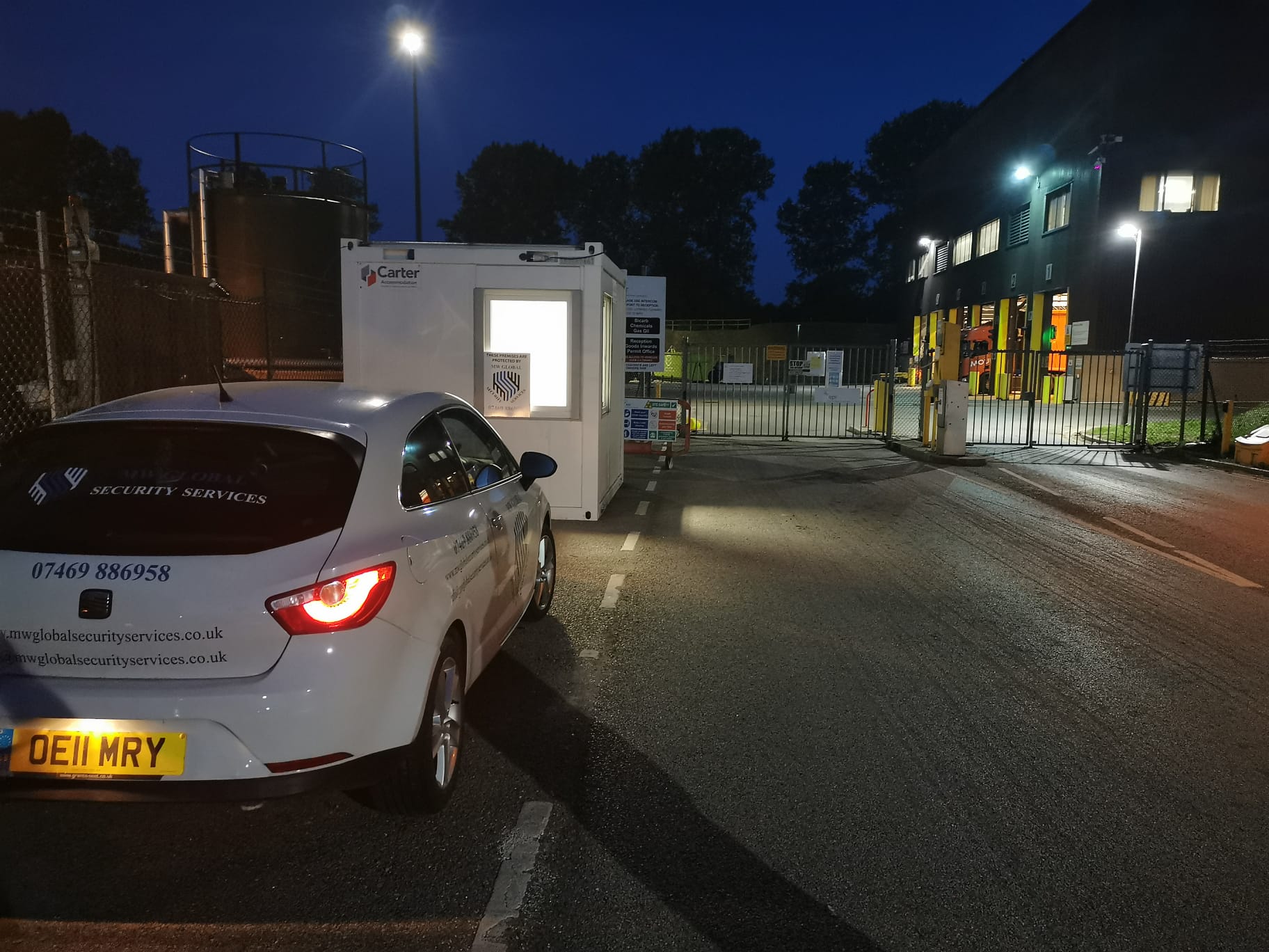 Gatehouse security cabin protecting industrial site entrance during night operations